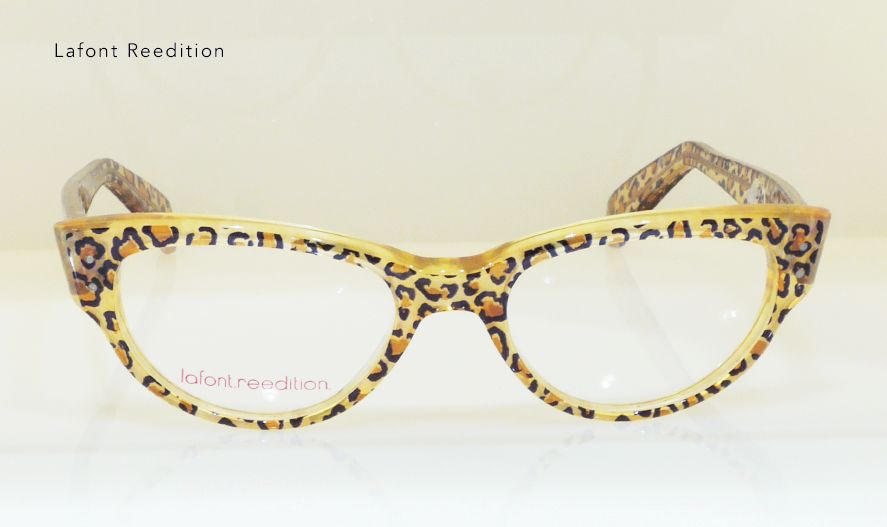 Leopard-print eyeglasses with clear lenses against a neutral background.