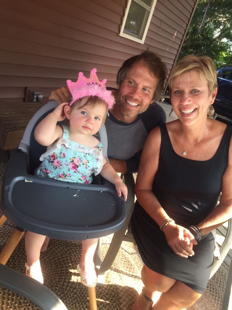 a little girl wearing a pink crown with the word hawk on it