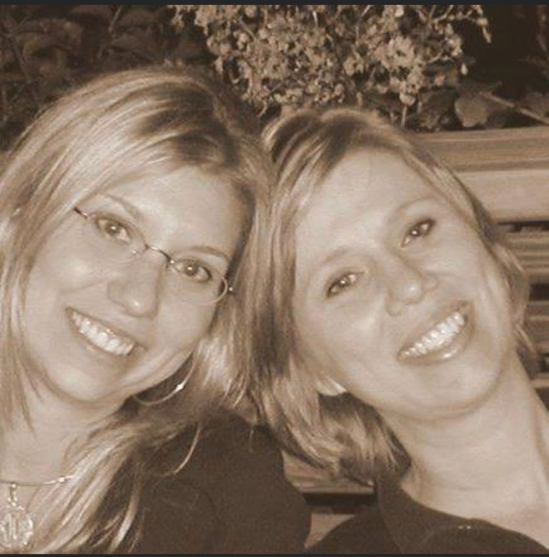 two women are posing for a picture and smiling for the camera