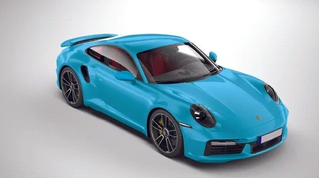 A man is wrapping a red car with a protective film.