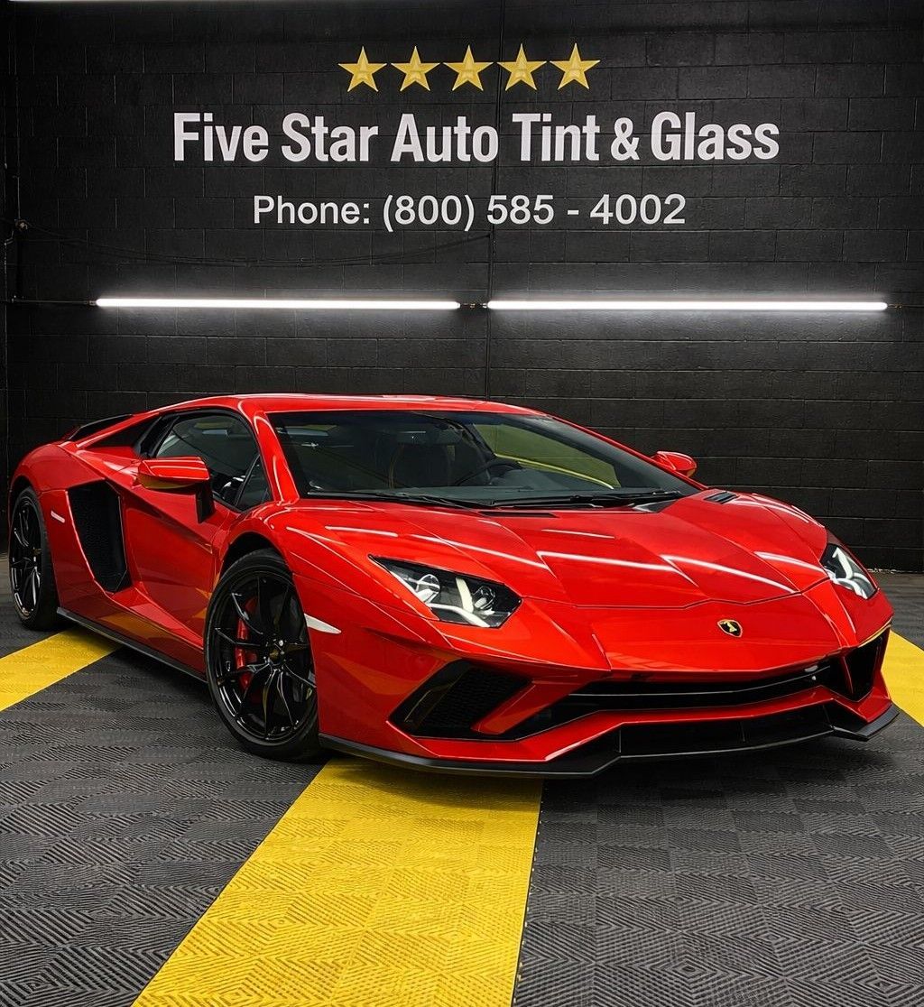 A white car is driving through a dirt field.