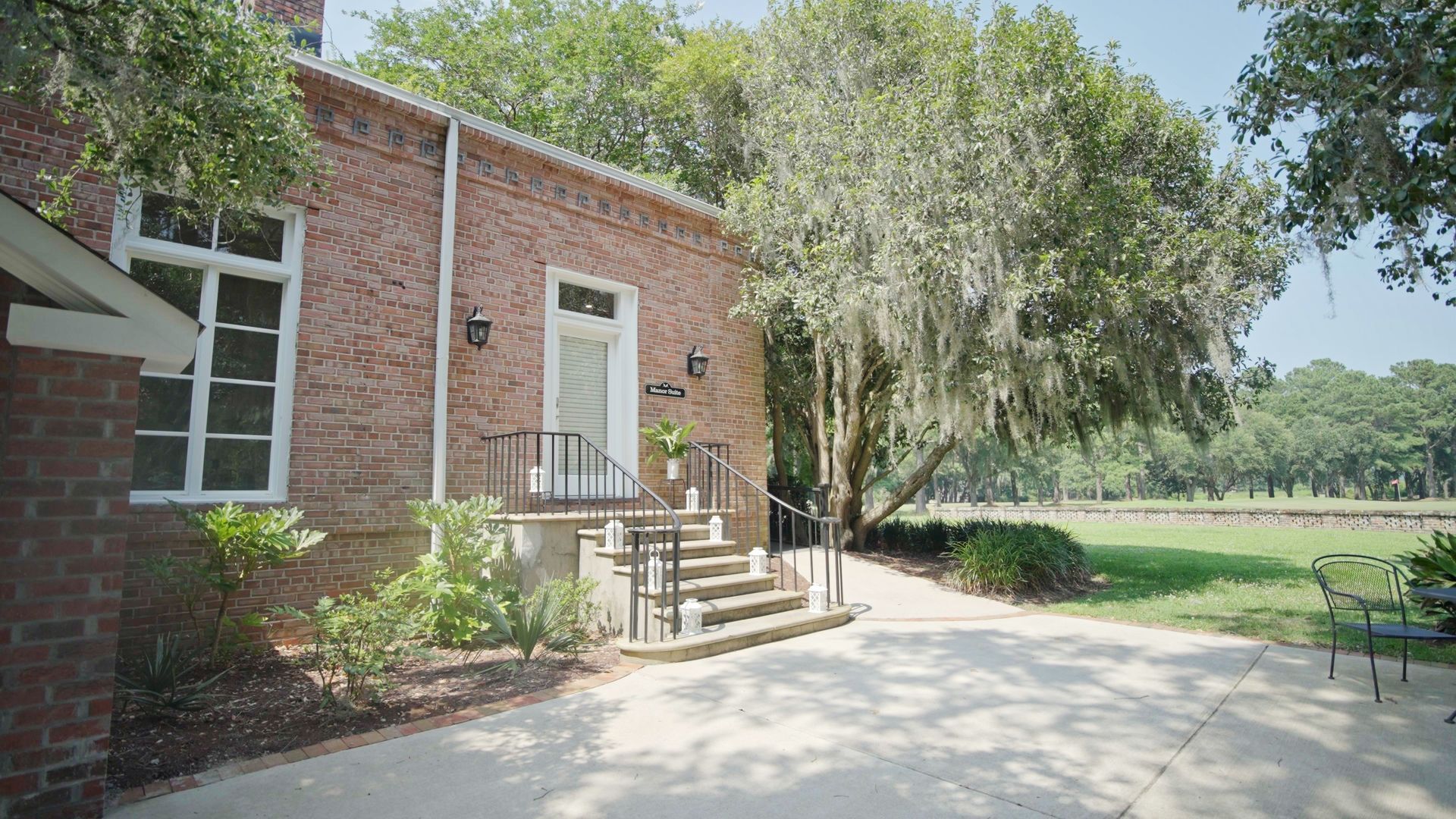 a brick building with stairs leading up to the front door .