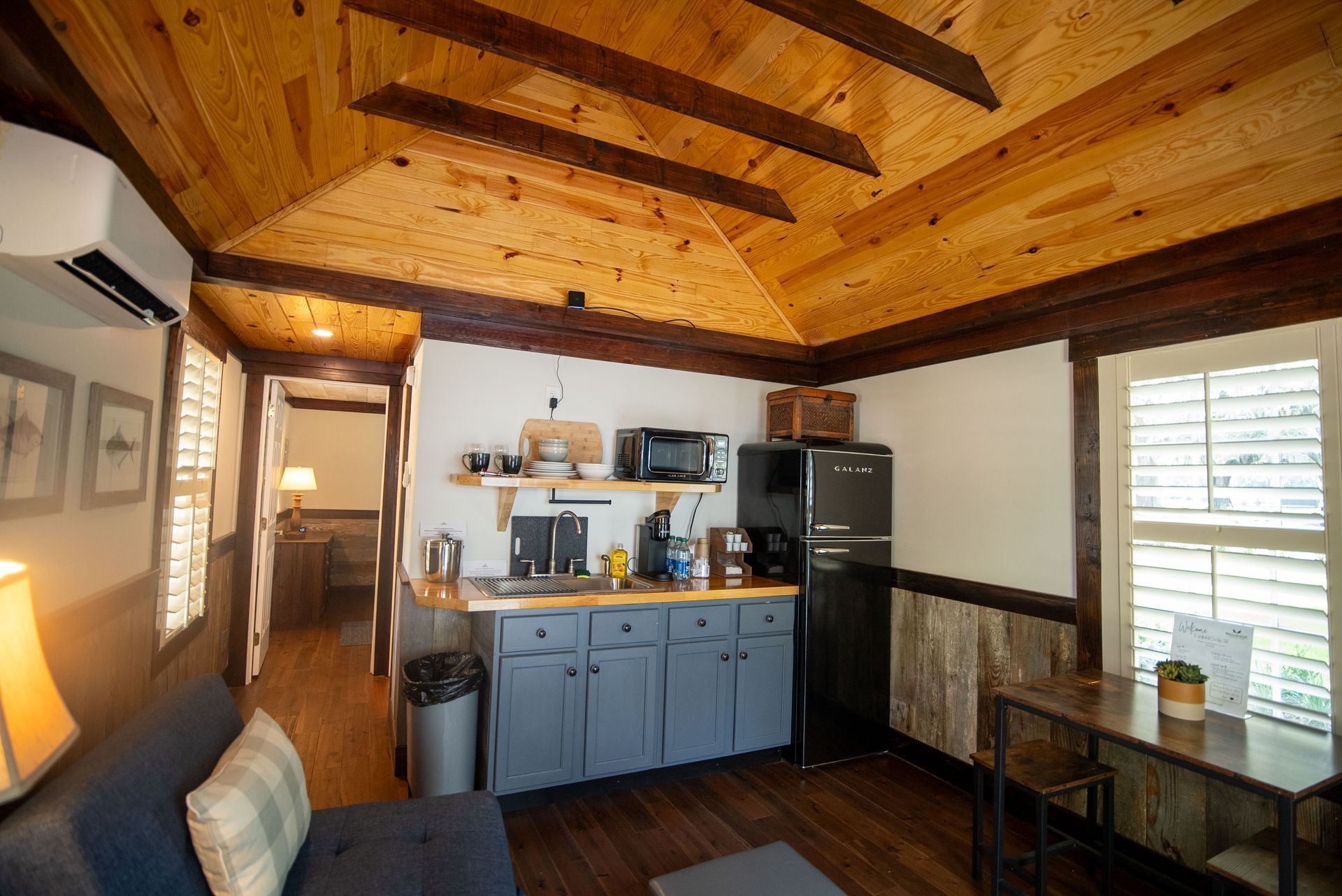 a living room with a kitchen and a couch
