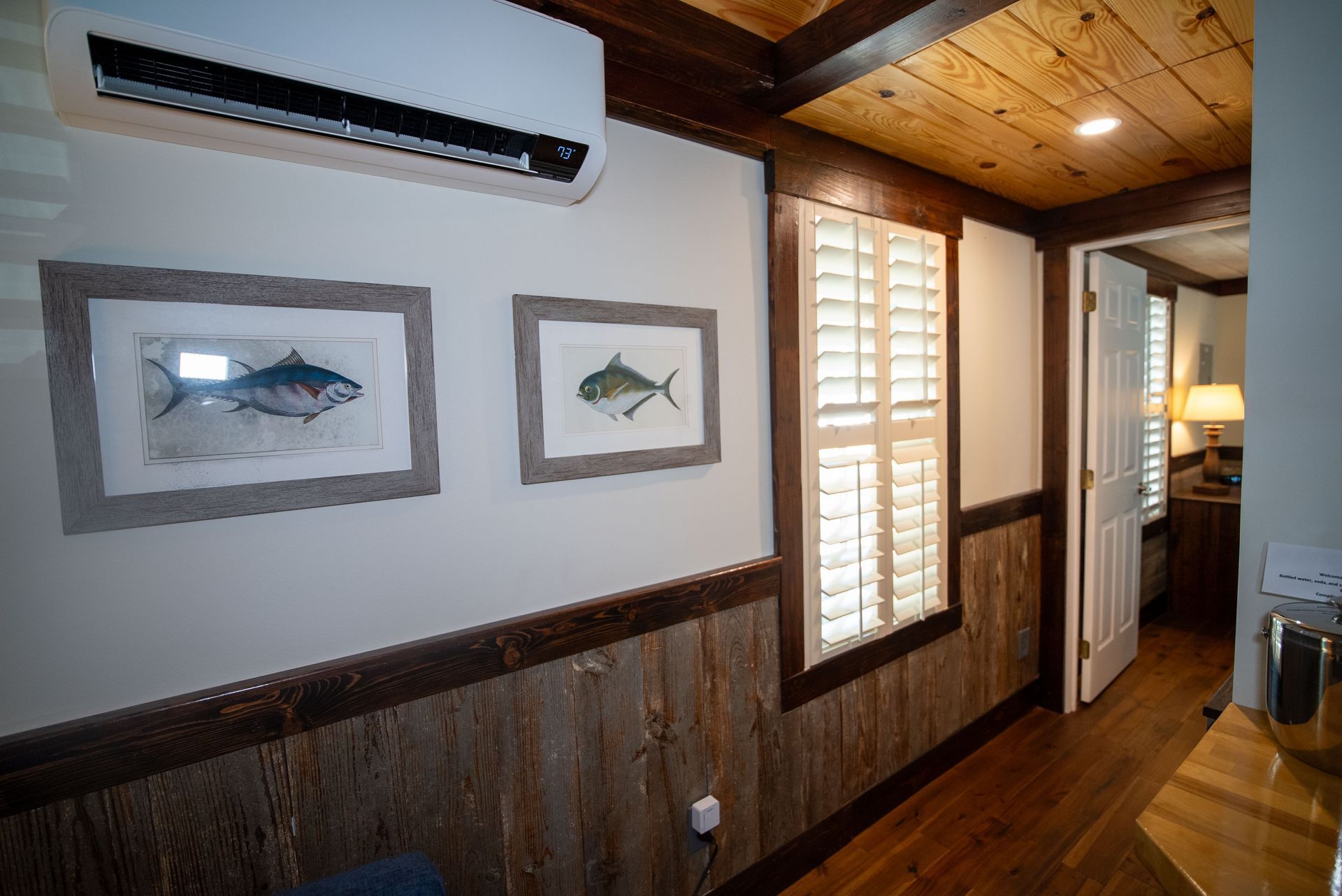 a hallway in a house with a picture of a fish on the wall .