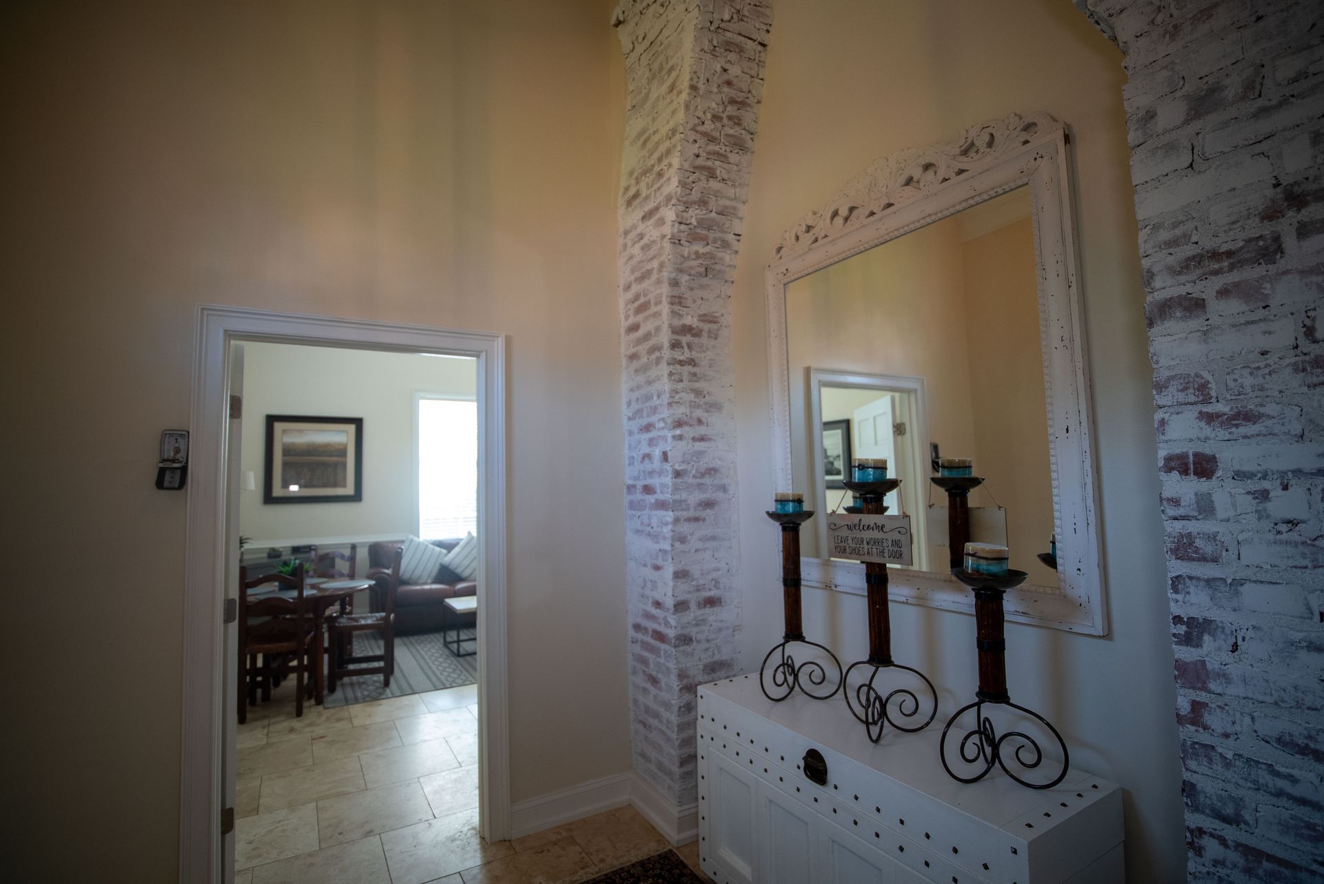 a hallway with a mirror and candles on a table .