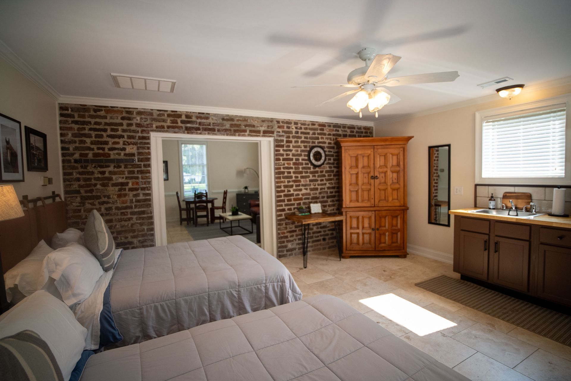 a bedroom with two beds and a ceiling fan