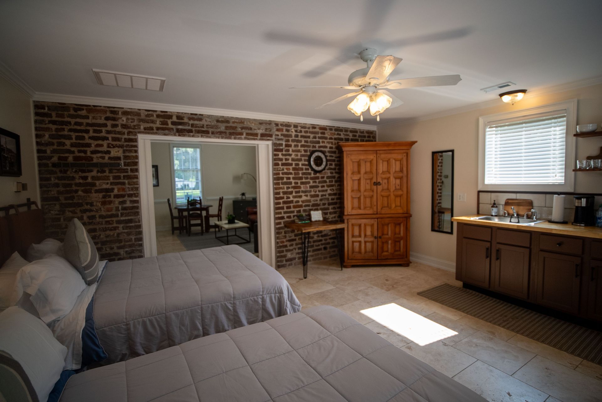 a bedroom with two beds and a ceiling fan