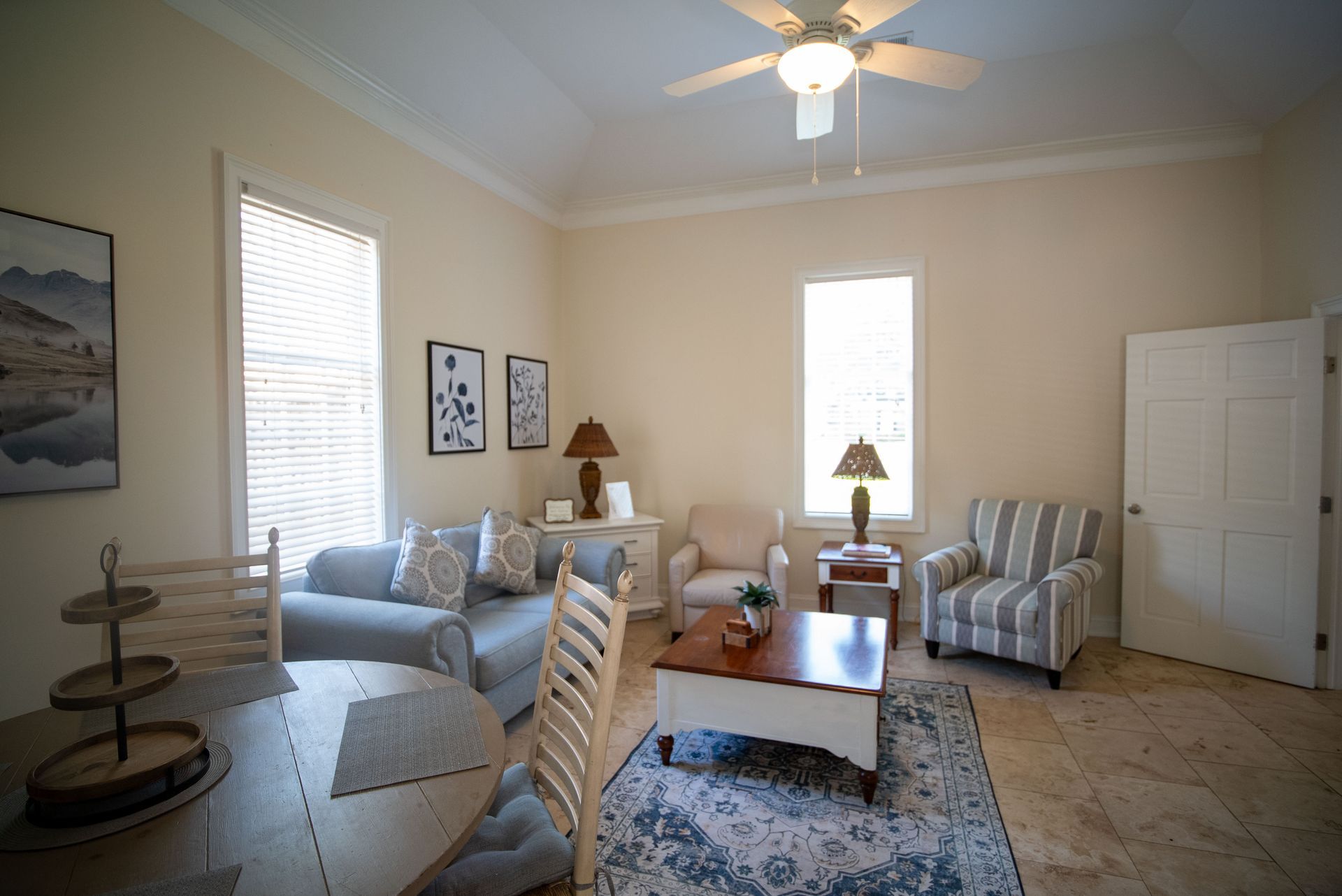a living room filled with furniture and a ceiling fan .