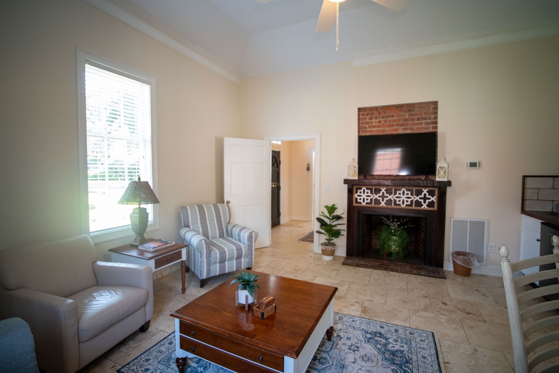 a living room filled with furniture and a ceiling fan .