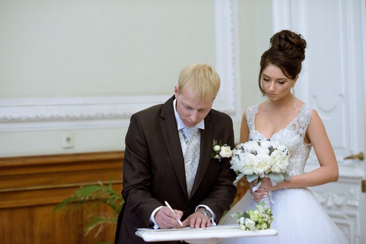 Beauty bride and handsome groom are registering the marriage