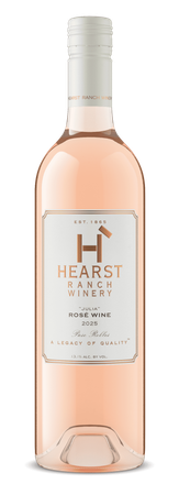 Bottle of Heartland rosé wine with a pale pink liquid and white cap on a white background