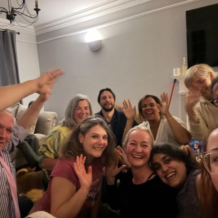 A group of people are posing for a picture in a living room