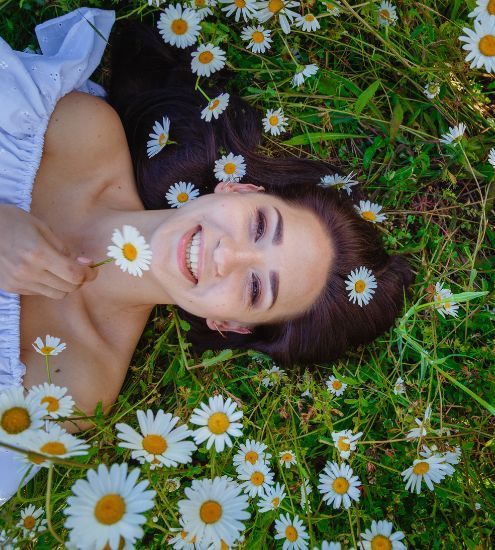 woman on the grass and flowers
