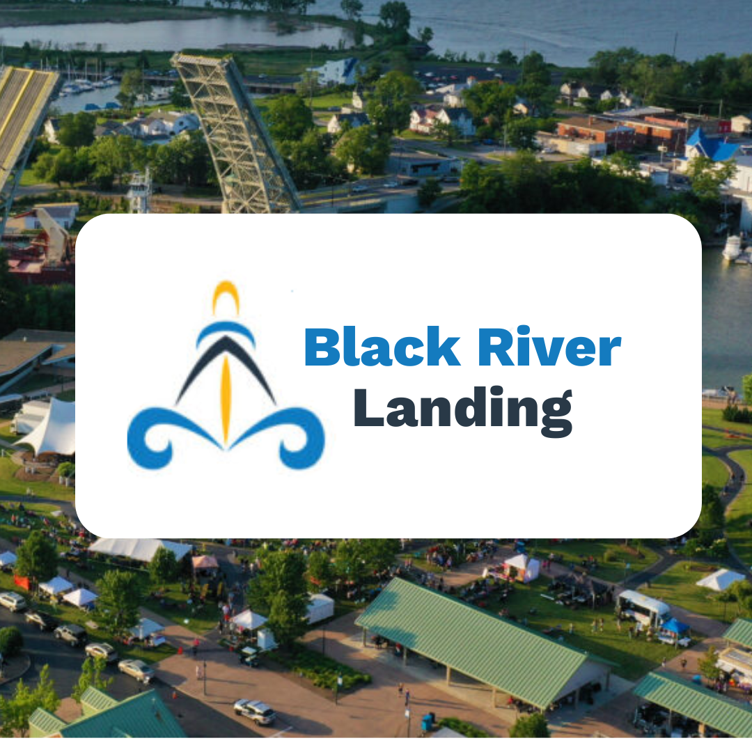 A logo for black river landing with an aerial view in the background