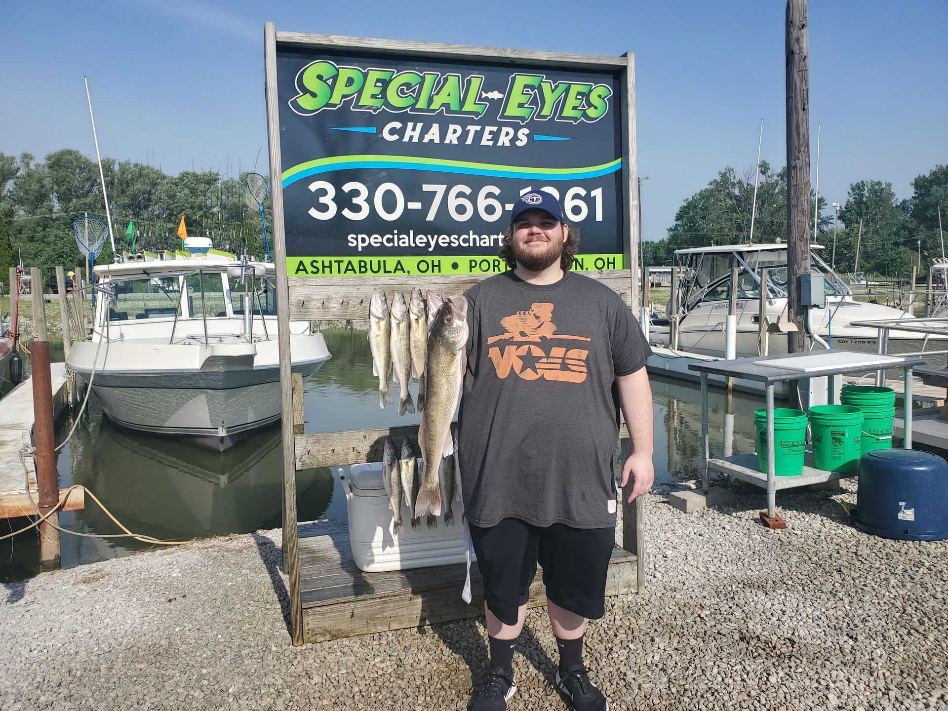 A man is standing in front of a sign that says special eyes charters.