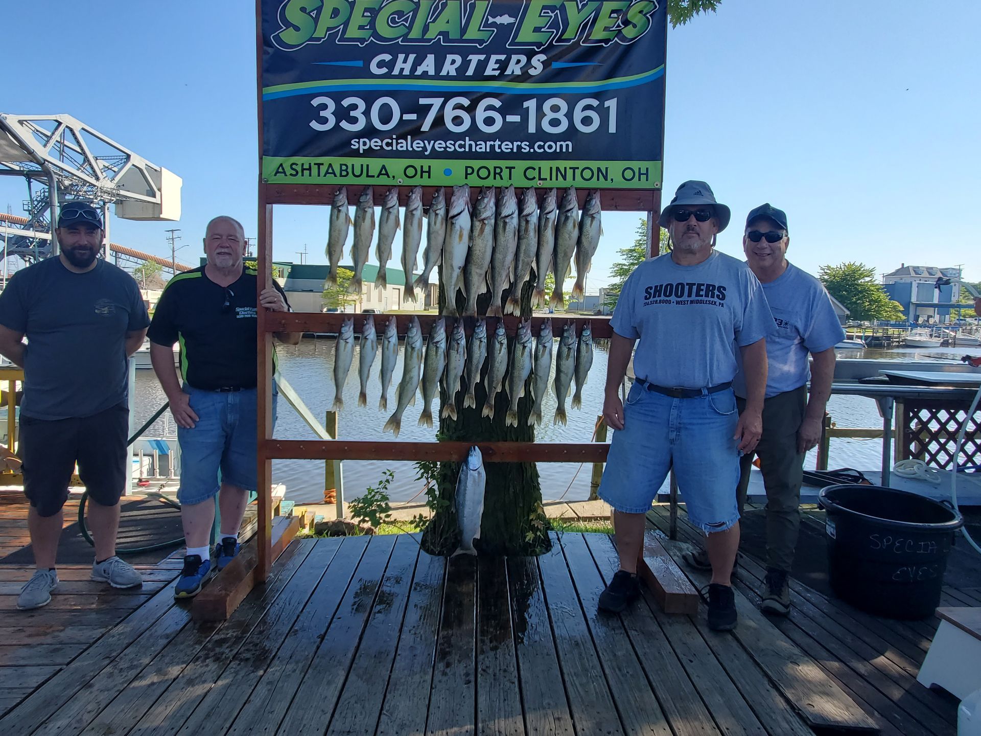 A group of men standing next to a sign that says special eyes charters