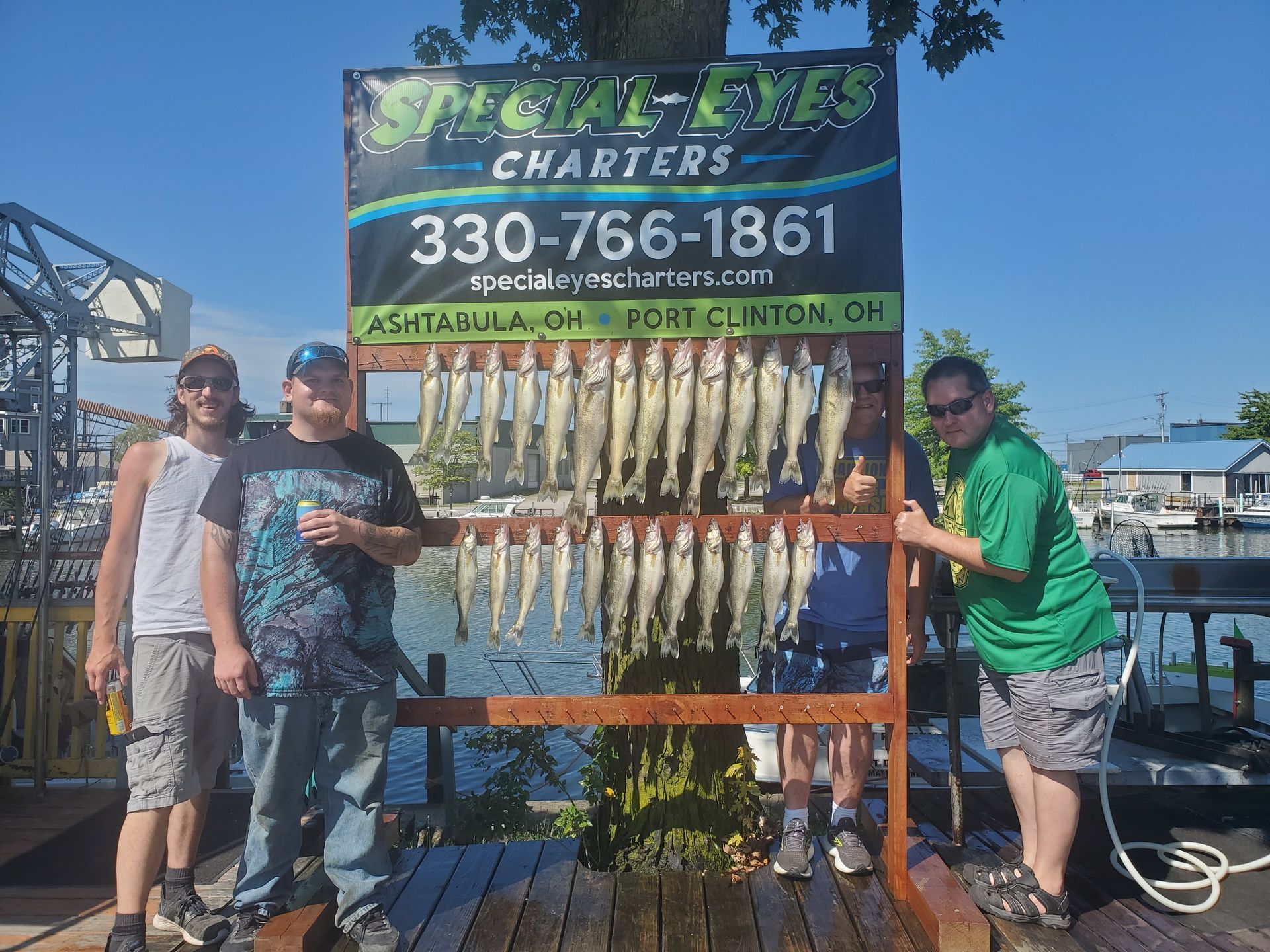 A group of men standing in front of a sign that says charters