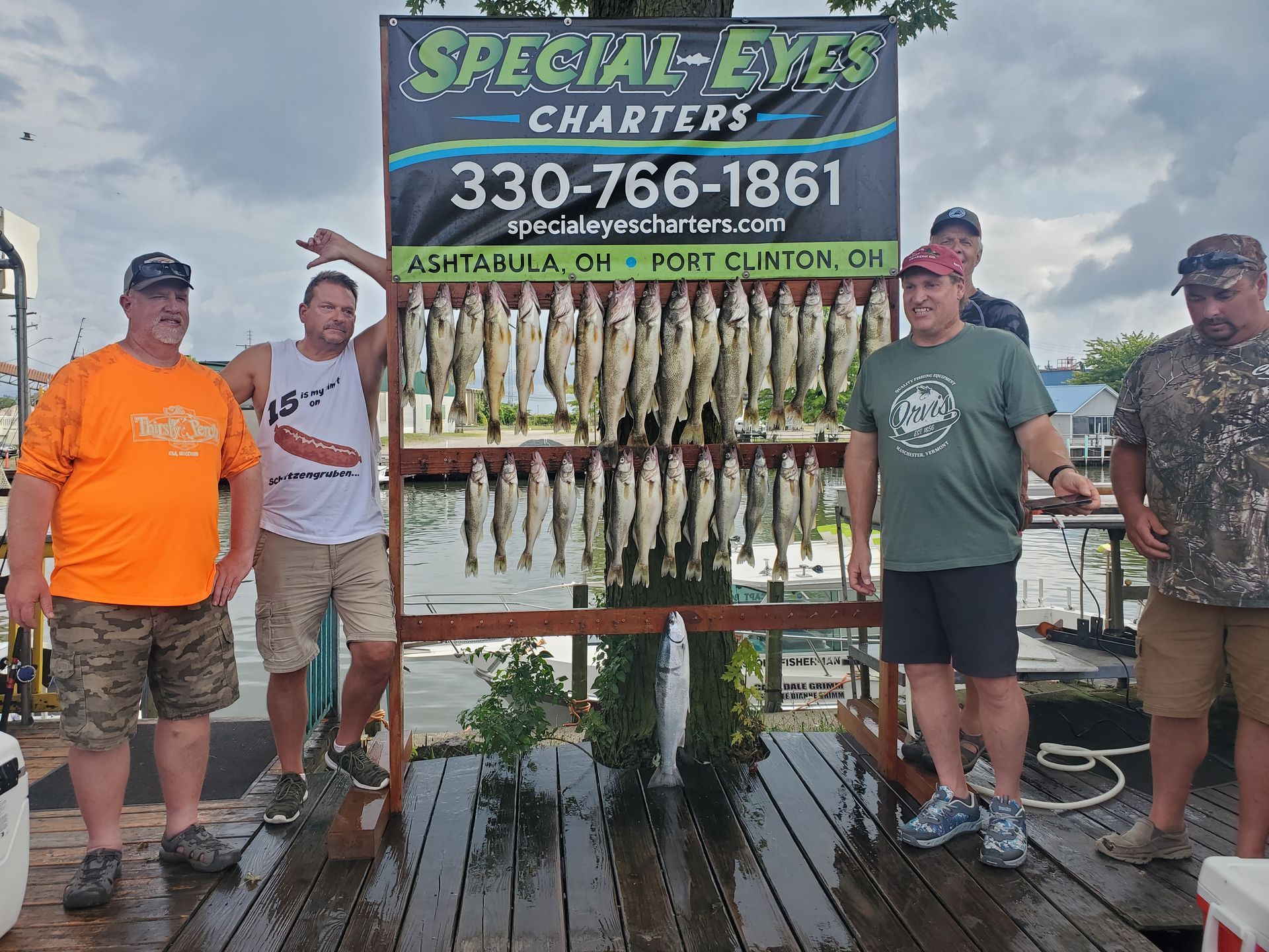 A group of men standing in front of a sign for special eyes charters