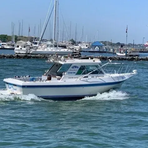 A white boat is floating on top of a body of water.