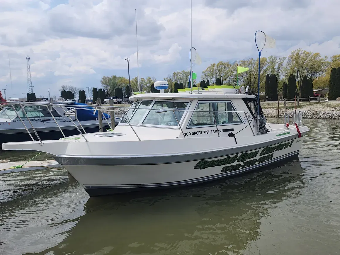A white boat is floating on top of a body of water.