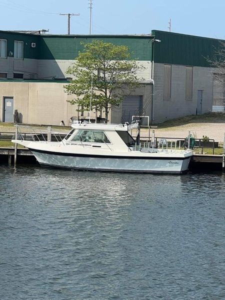 A boat is docked in the water in front of a building.