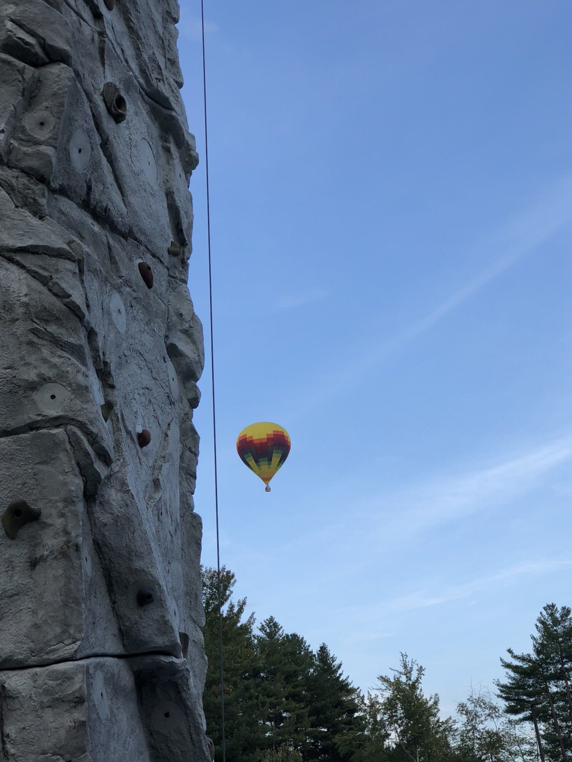 Rock Wall Climbing and Hot Air Balloon Against Sky Background — Chicopee, MA — Cliffhangers Portable Rock Climbing Wall