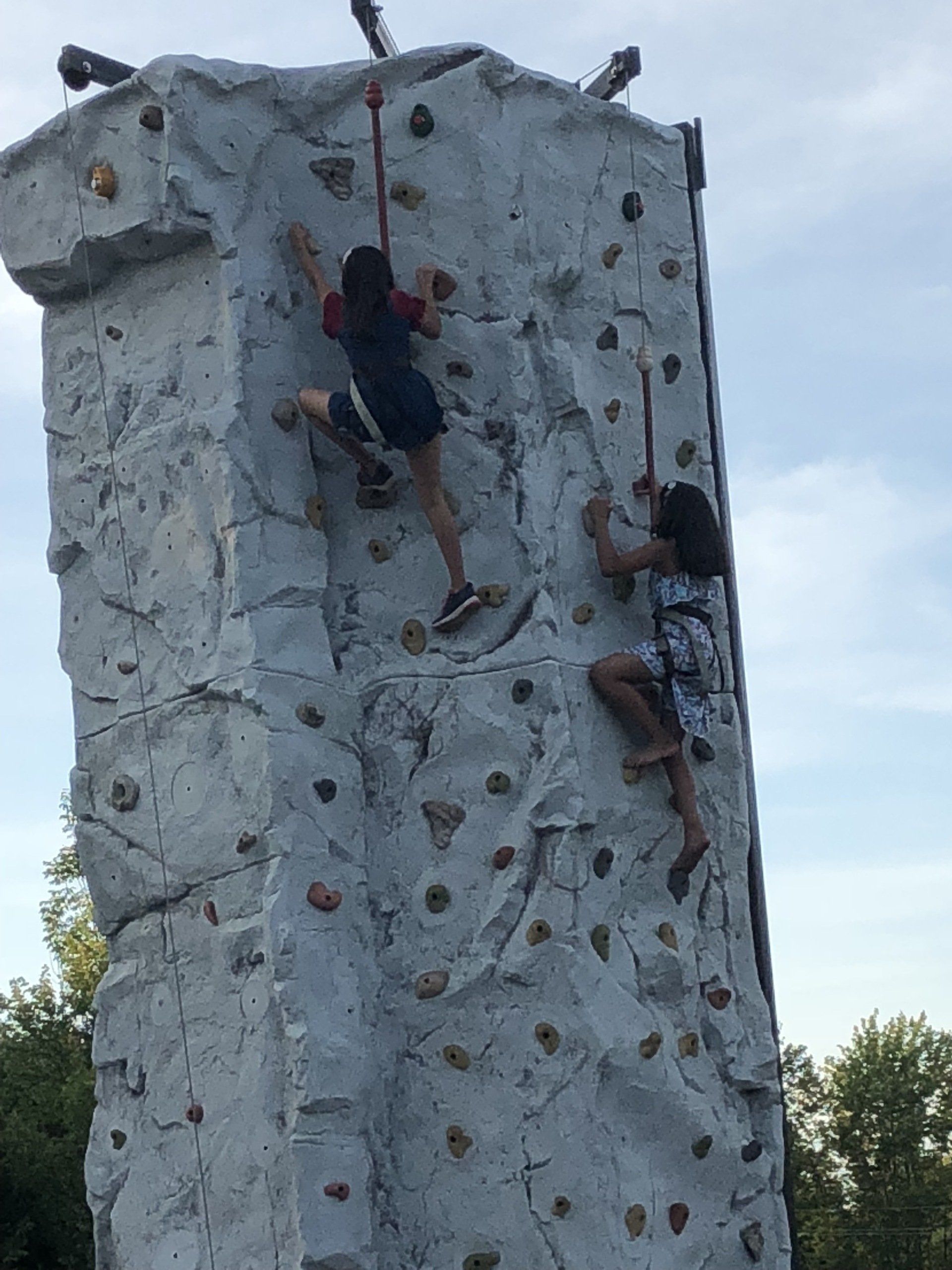 Two Girls Climbing the Top of The Rock Wall — Chicopee, MA — Cliffhangers Portable Rock Climbing Wall