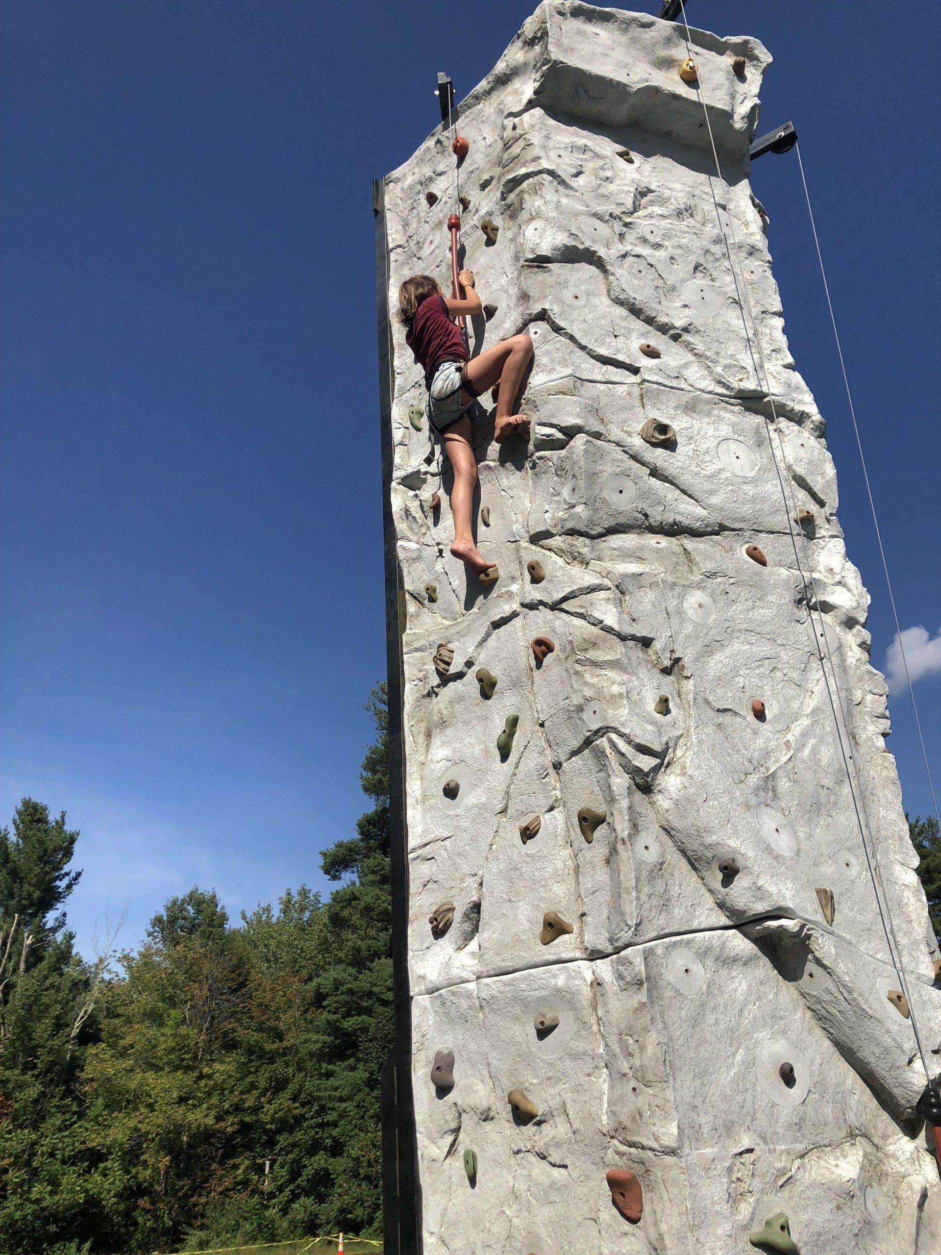 Girl Climbing on The Top — Chicopee, MA — Cliffhangers Portable Rock Climbing Wall