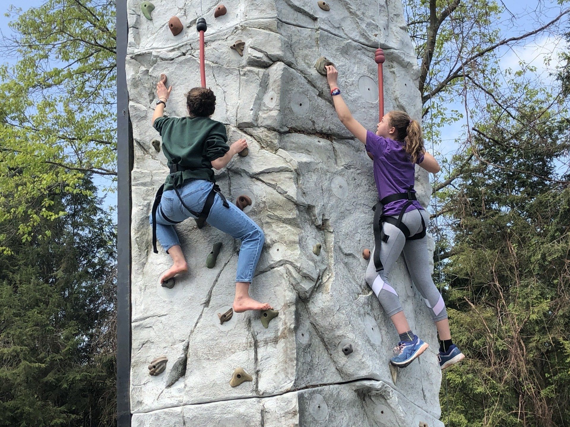 Two Women Climbing on The Portable Rock Wall Climbing — Chicopee, MA — Cliffhangers Portable Rock Climbing Wall
