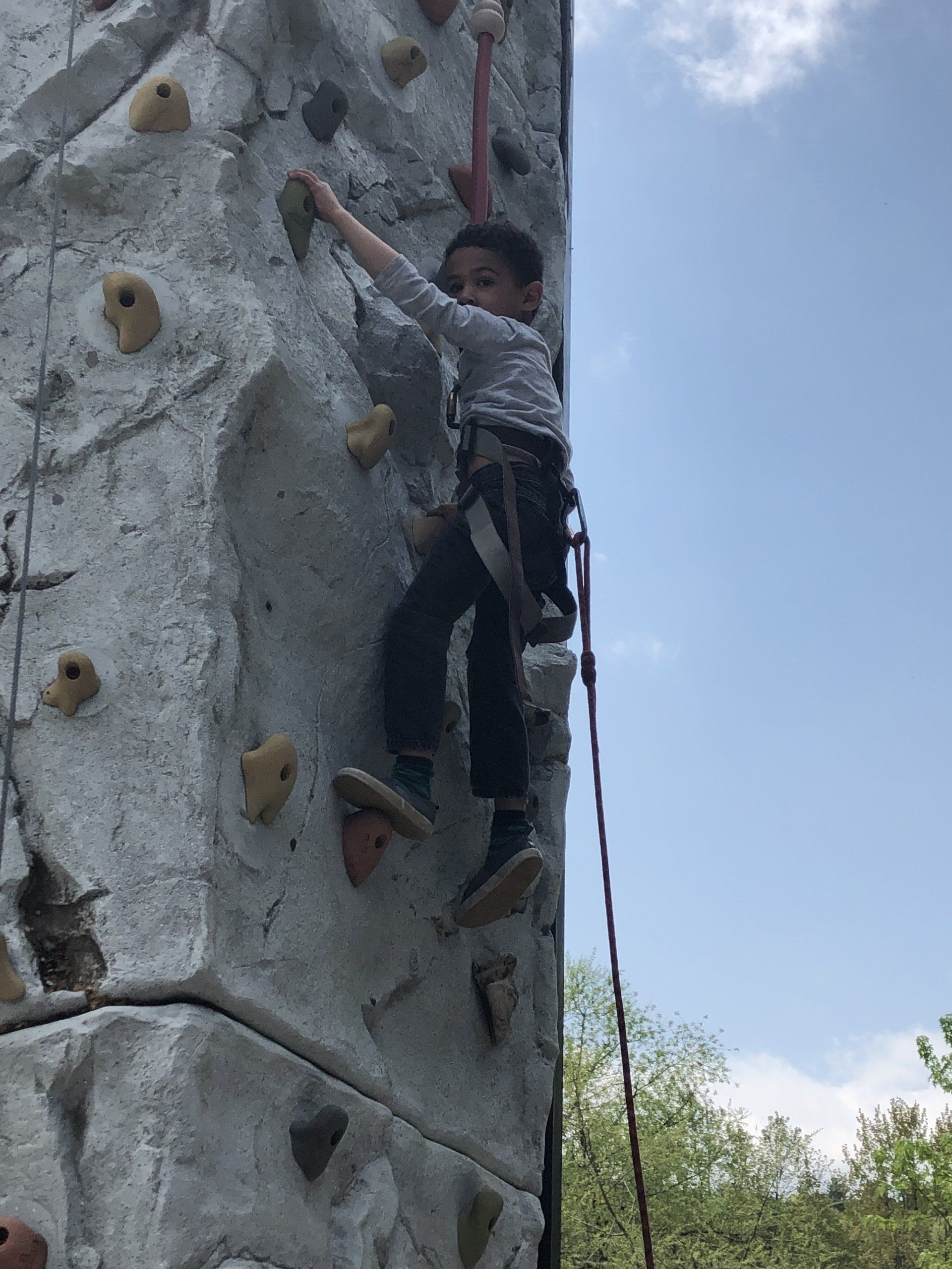 Brave Boy Climbing On the Portable Rock Wall Climbing — Chicopee, MA — Cliffhangers Portable Rock Climbing Wall
