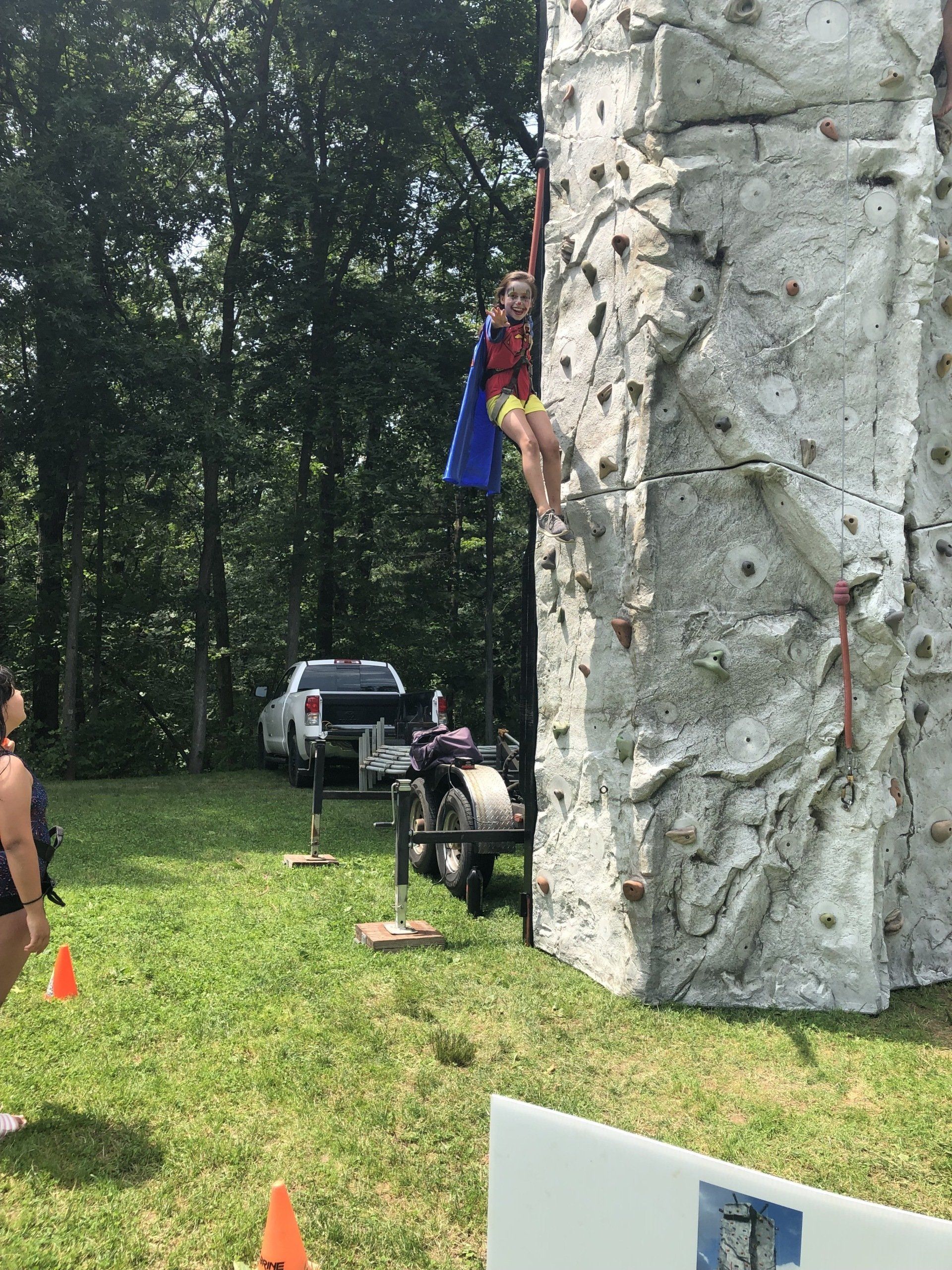 Girl Smiling While Climbing — Chicopee, MA — Cliffhangers Portable Rock Climbing Wall