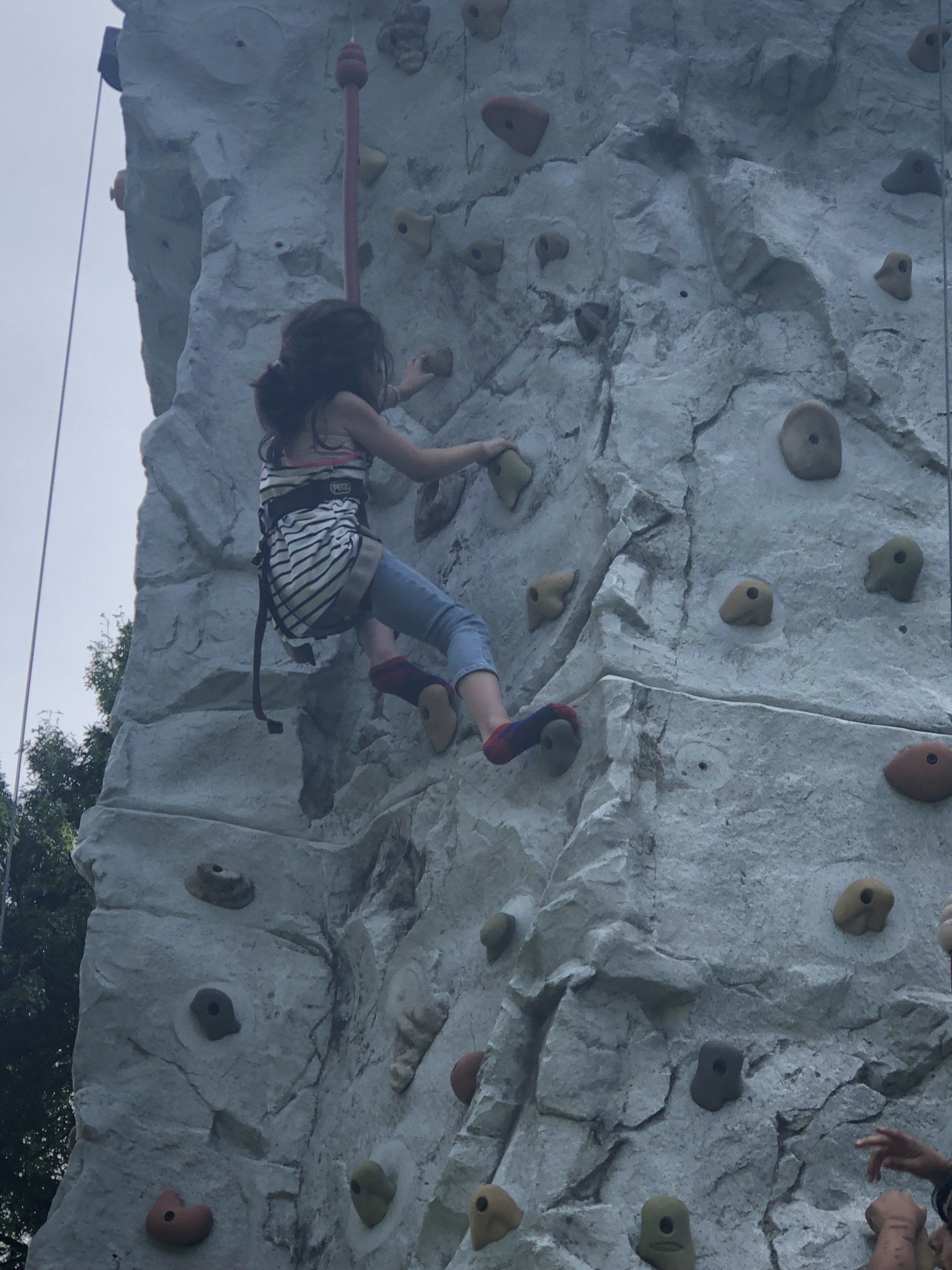 Girl Climbing on The Rock Wall Climbing — Chicopee, MA — Cliffhangers Portable Rock Climbing Wall