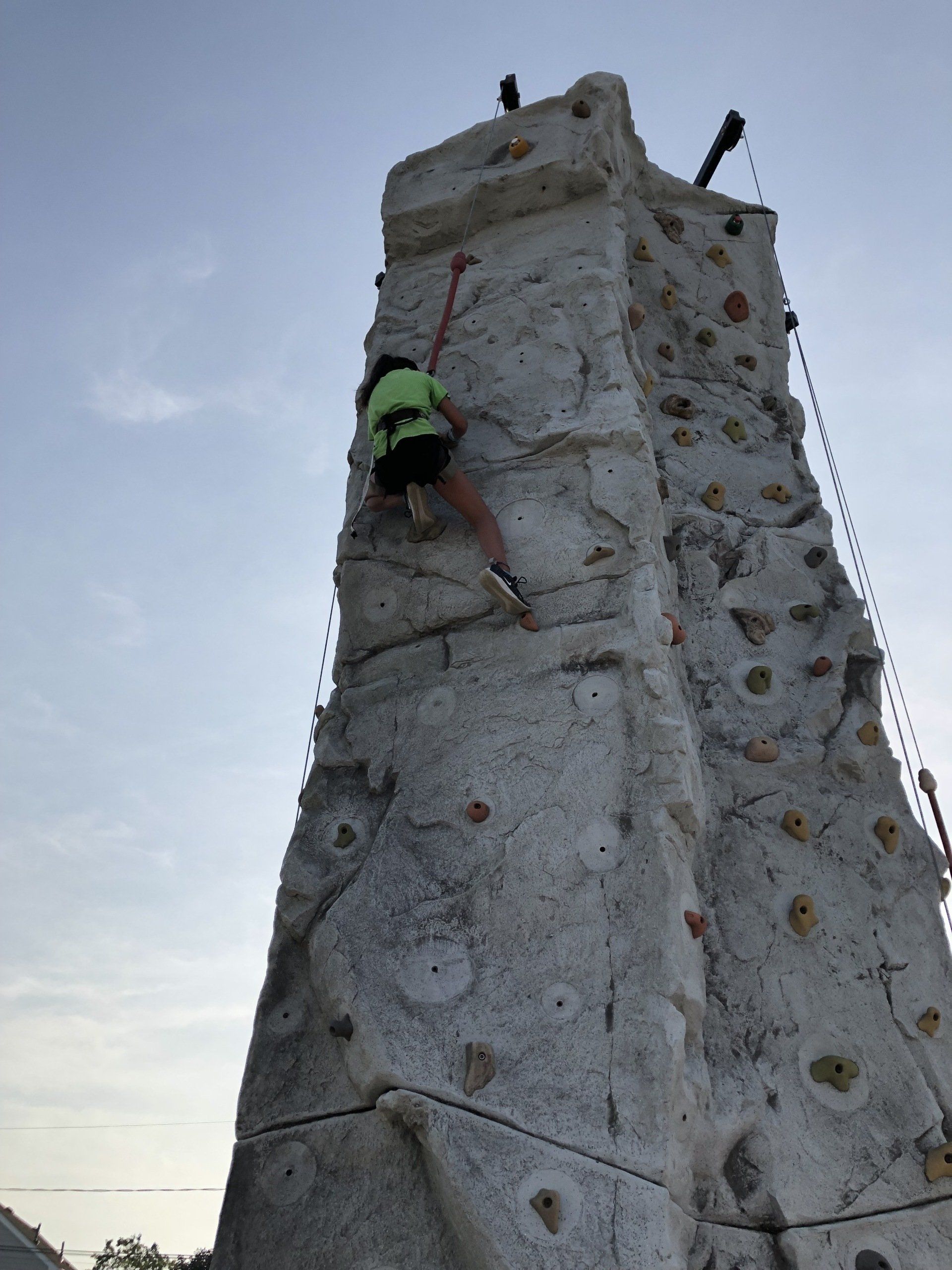 Woman on The Top of The Portable Climbing Wall — Chicopee, MA — Cliffhangers Portable Rock Climbing Wall
