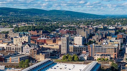 An aerial view of a city with mountains in the background.