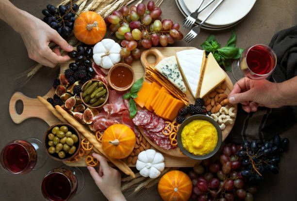 A table topped with a variety of food and wine glasses.