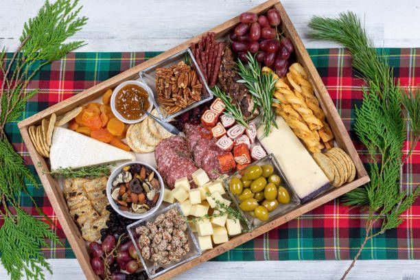 A wooden tray filled with lots of different types of food.
