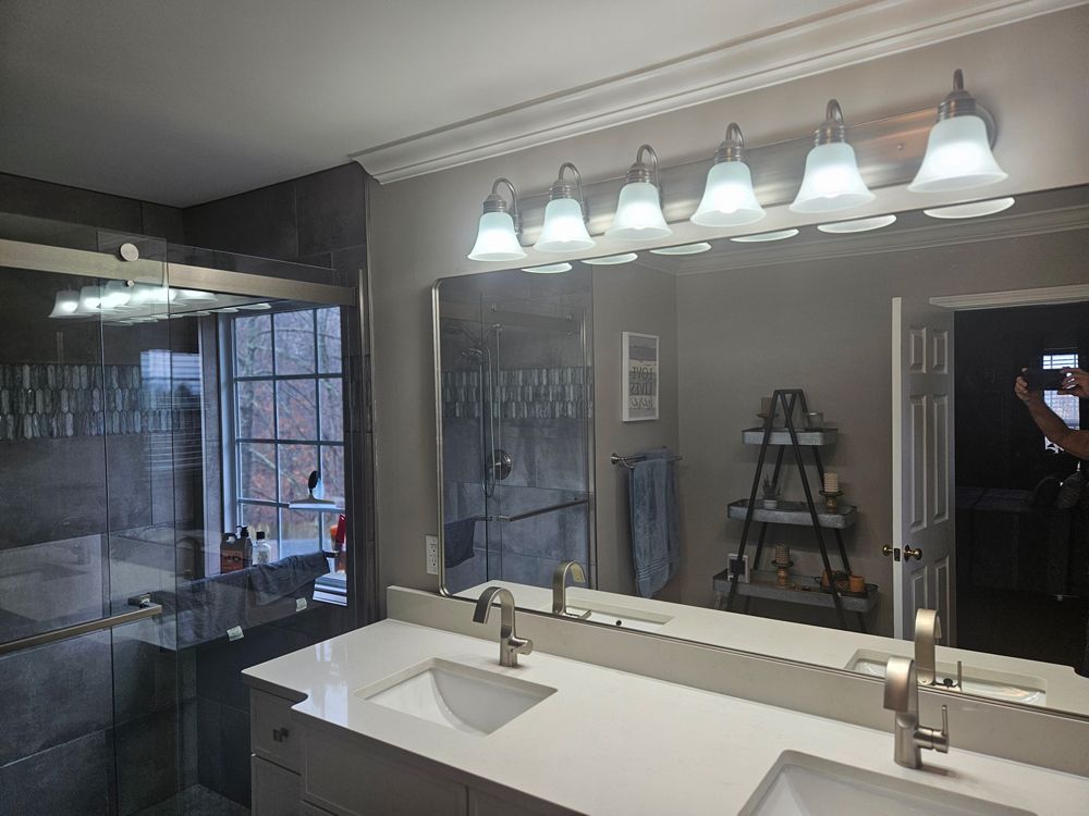 A bathroom with two sinks and a large mirror.