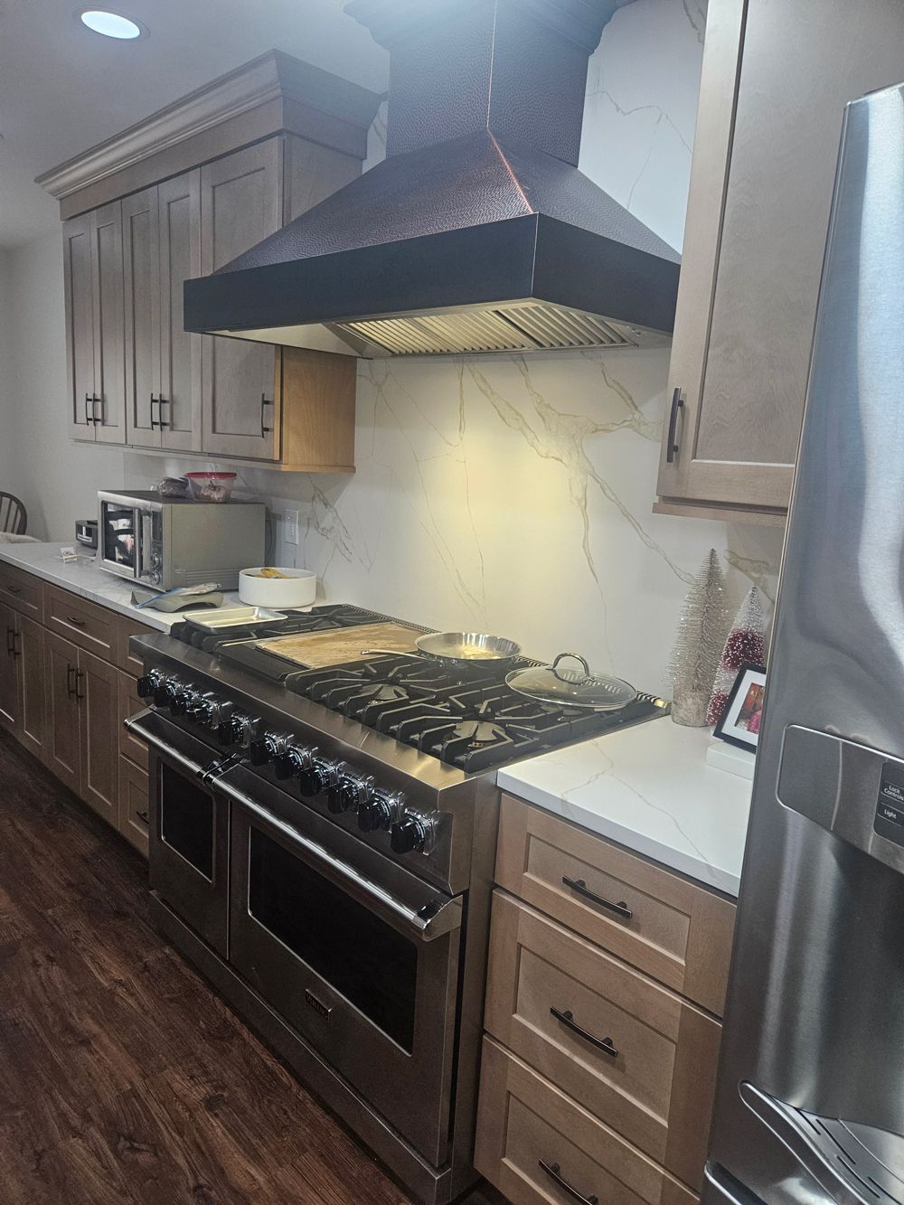 A kitchen with stainless steel appliances and wooden cabinets.