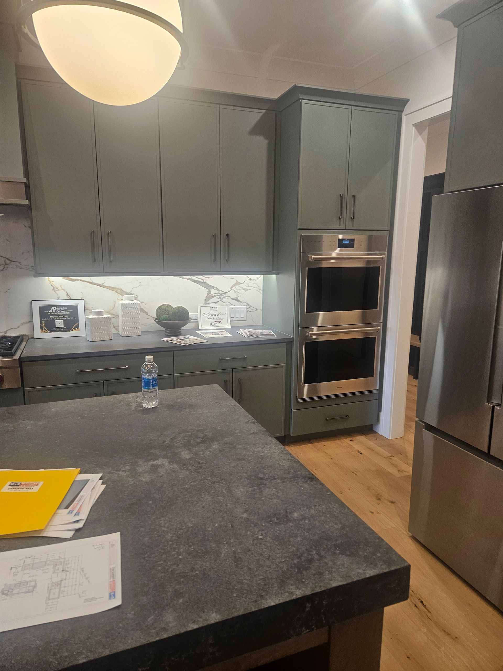 A kitchen with stainless steel appliances and a large island.