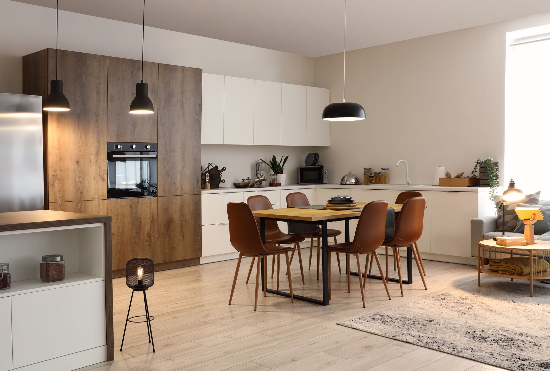 A kitchen with a dining table and chairs in it.