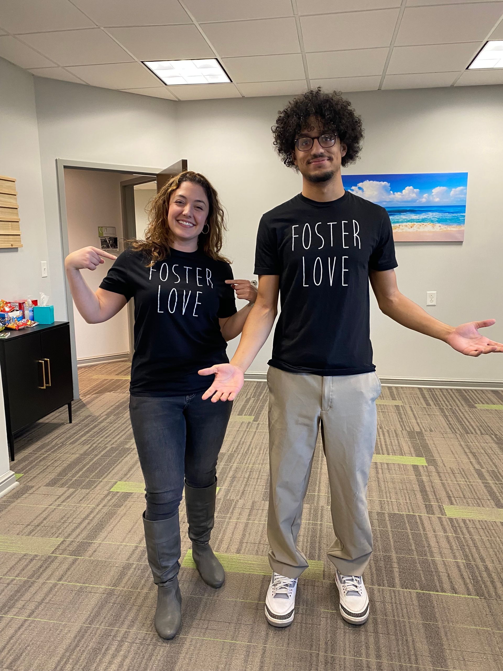 A man and a woman are standing next to each other in a room.