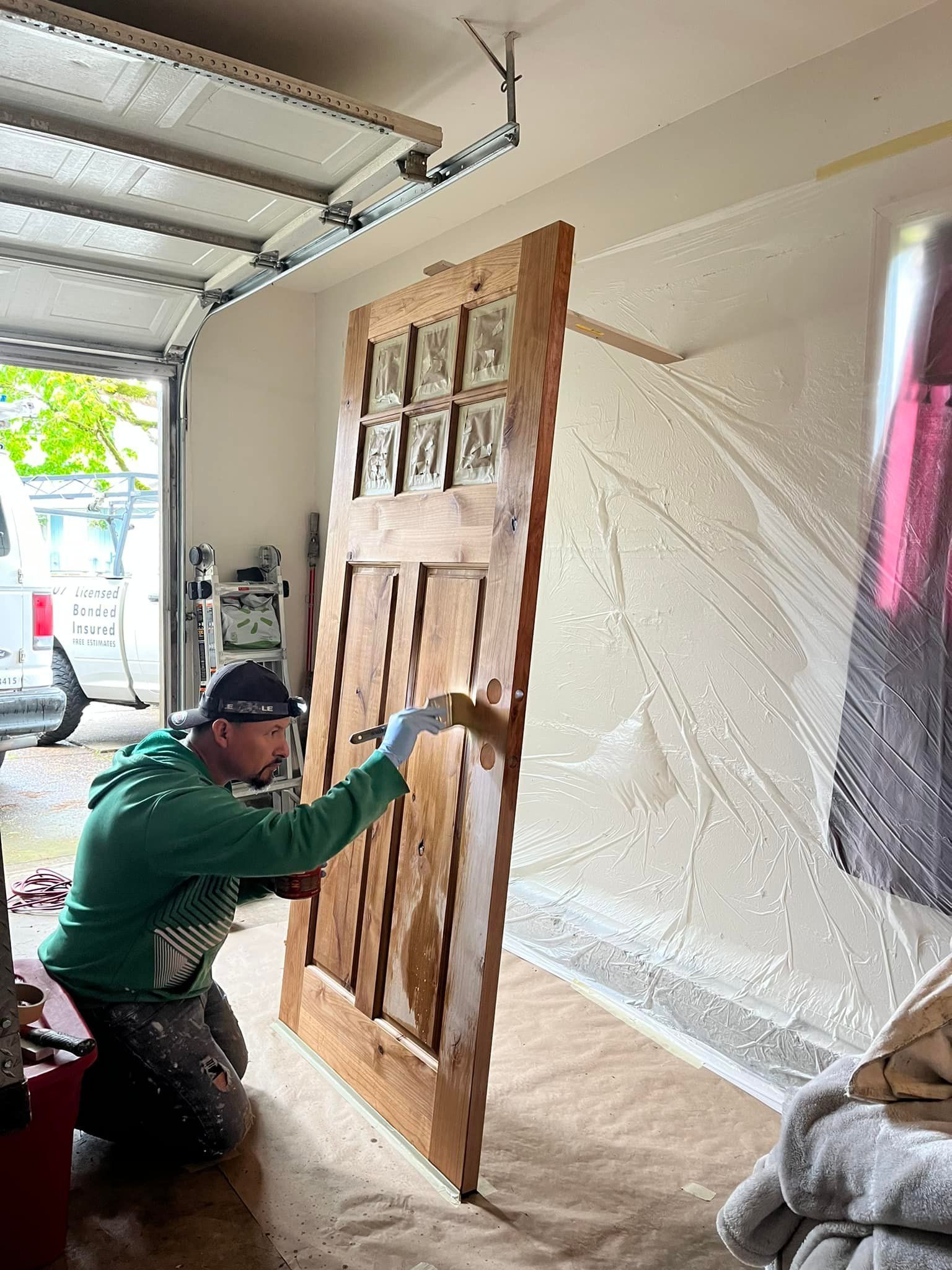 Worker doing door painting job