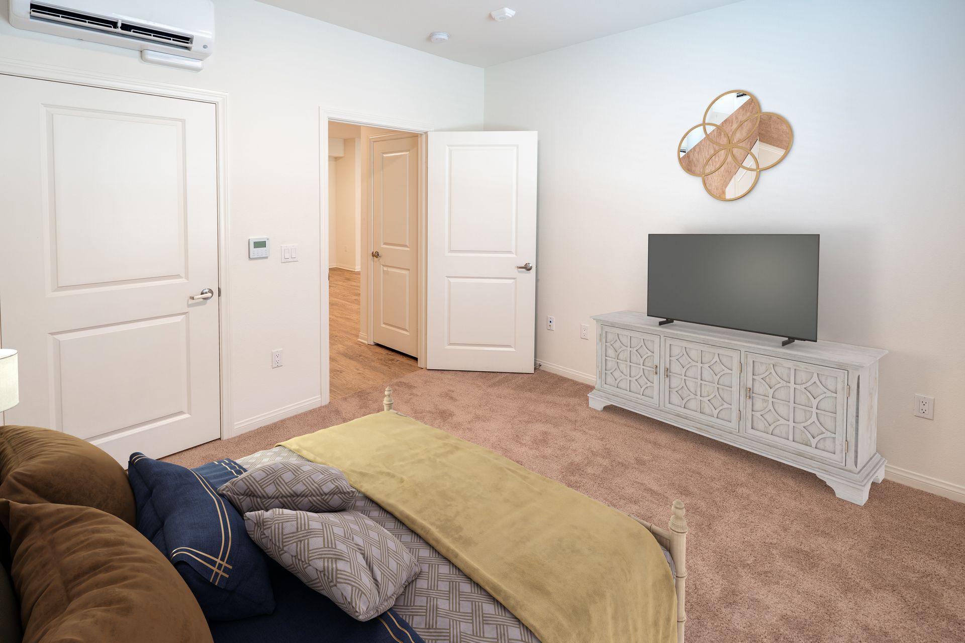 A bed room with a bed and a door open