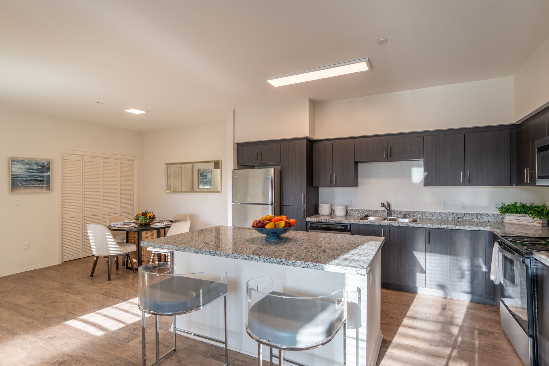 A kitchen with a center island and stainless steel appliances