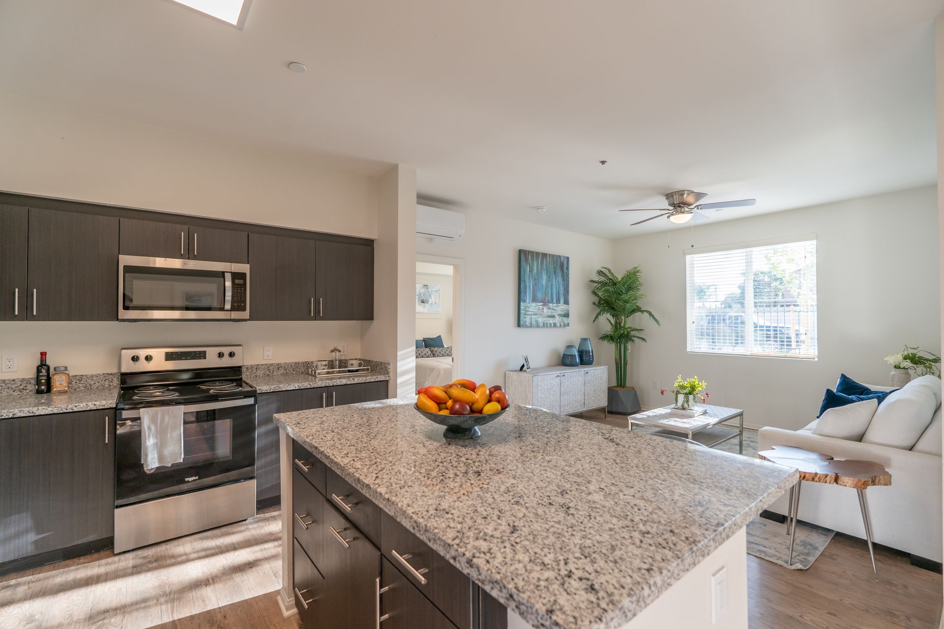 A kitchen with a center island and stainless steel appliances