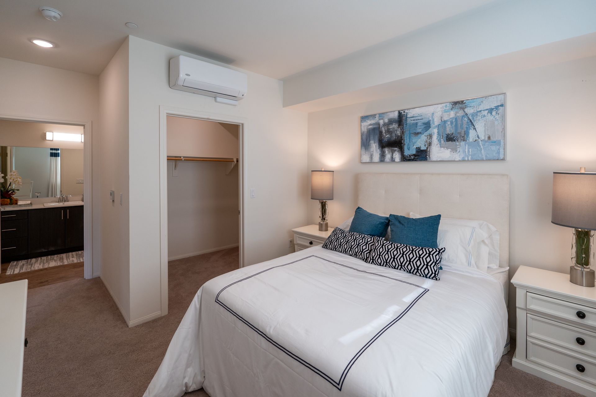 A bedroom with a bed and a walk-in closet