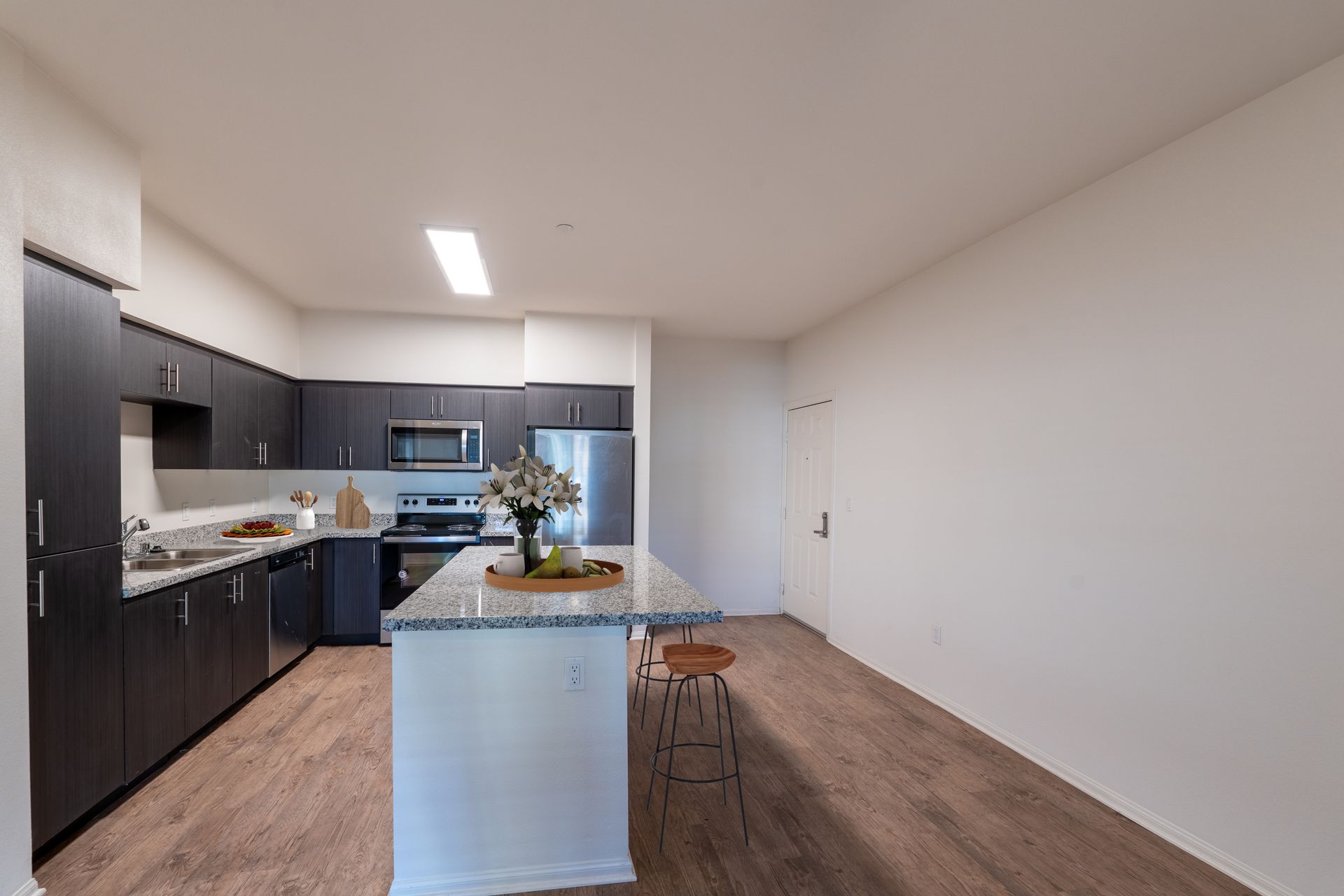 A kitchen with a center island and stainless steel appliances