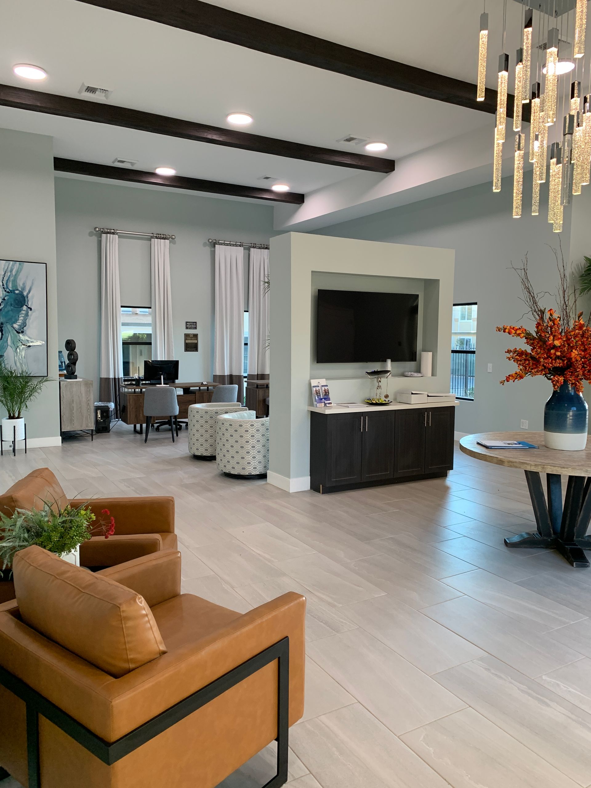 a living room with chairs , a table and a television