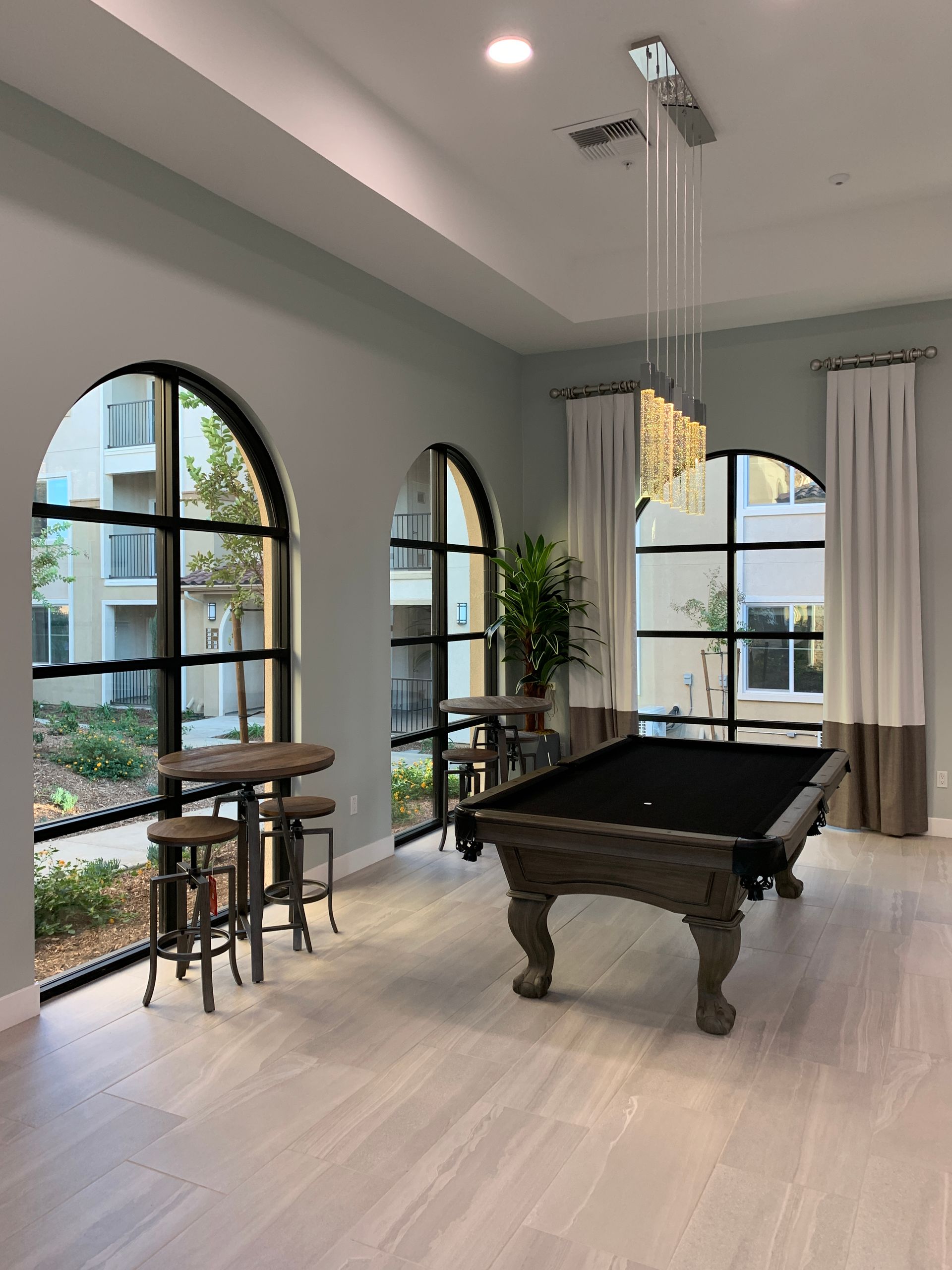 there is a pool table in the middle of the room .