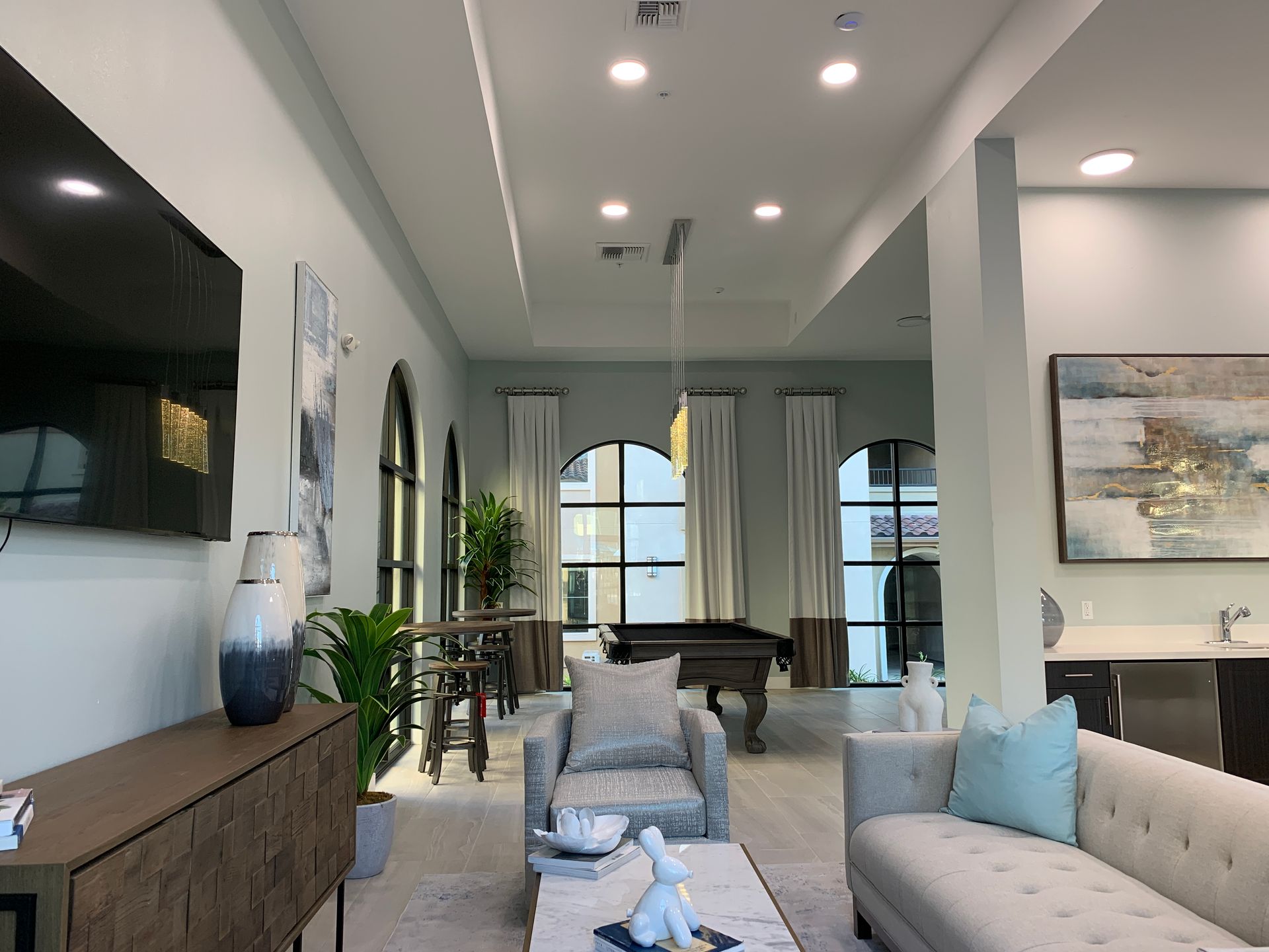 a living room with a pool table and a couch